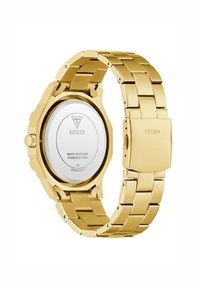 Montre en acier inoxydable doré avec un boîtier hexagonal, étanche, bracelet métallique et fermoir, dotée d'un cadran circulaire argenté à l'arrière.