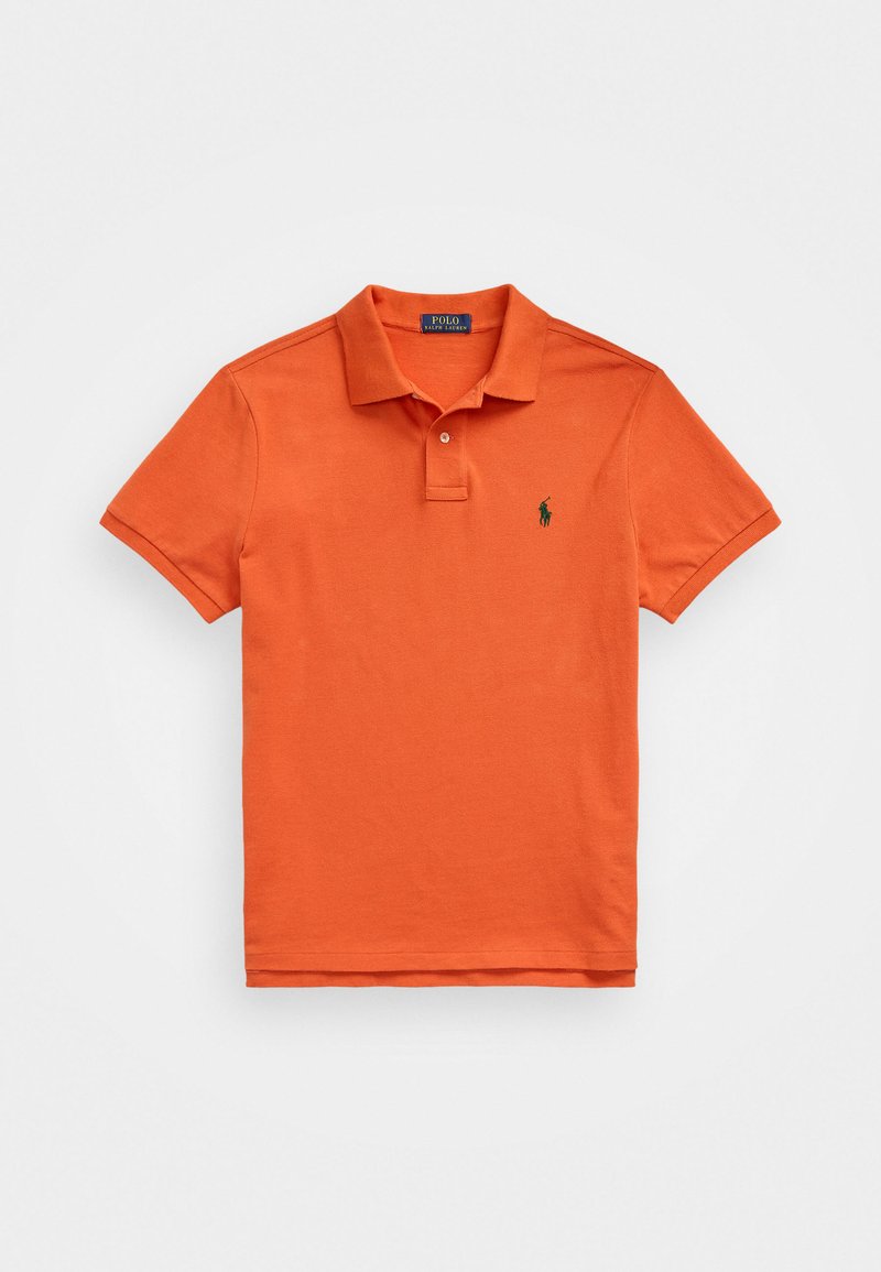 Orange polo shirt made of cotton, featuring a classic collar, short sleeves, and a small green embroidered logo on the left chest.