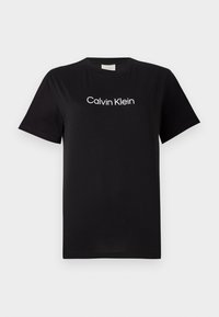 Zwarte katoenen t-shirt met korte mouwen, voorzien van een wit logo "Calvin Klein" dat over de borst is gedrukt. Klassiek rondhals ontwerp.