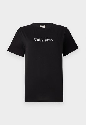 Black cotton t-shirt with short sleeves, featuring a white logo "Calvin Klein" printed across the chest. Classic crew neck design.