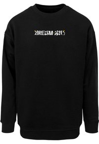 Felpa nera con la scritta "DREAM BIG" in una combinazione di bianco e giallo. Il design ha una vestibilità comoda con polsini e scollatura a costine.
