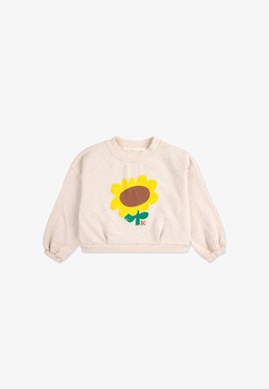 Felpa cropped beige chiaro con una grande grafica di girasole giallo, centro marrone e gambo verde. Presenta un colletto e dei polsini a coste.