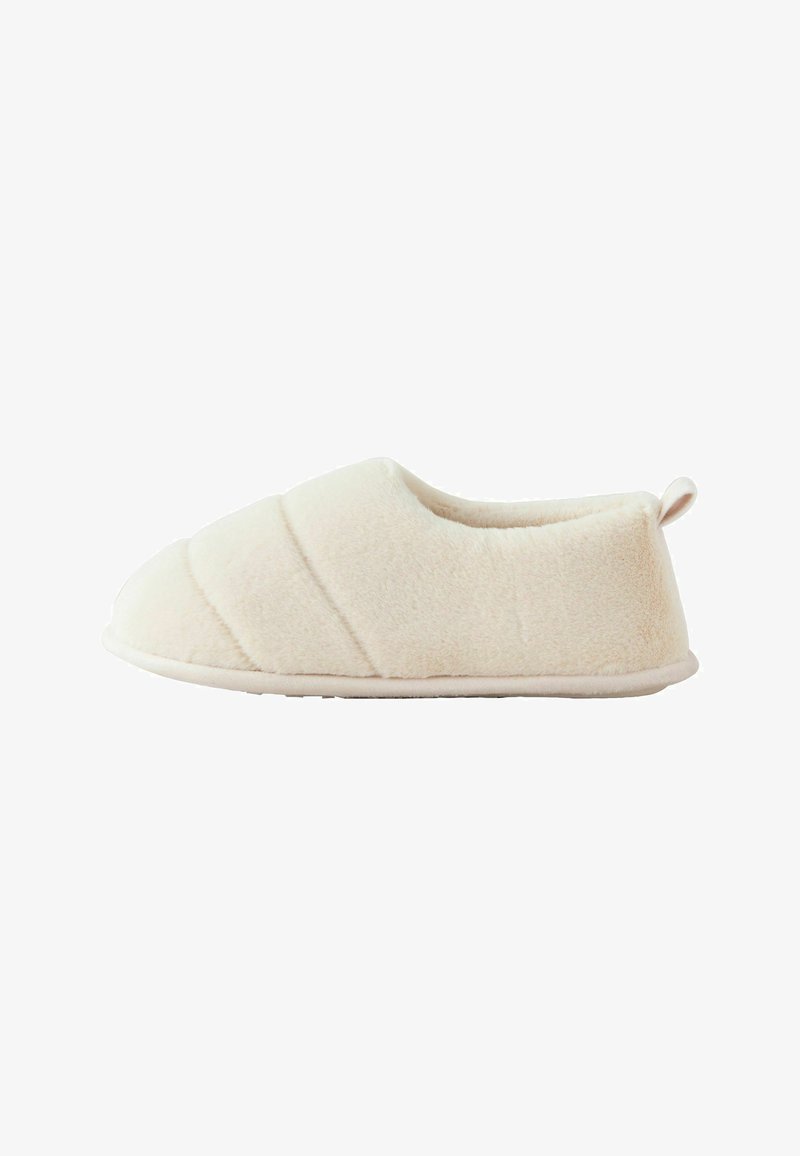 Weiche, cremefarbene Hausschuhe aus plüschigem Stoff. Sie haben eine abgerundete Zehenpartie, ein gesteppter Design auf der Vorderseite und eine kleine Schlaufe an der Ferse.