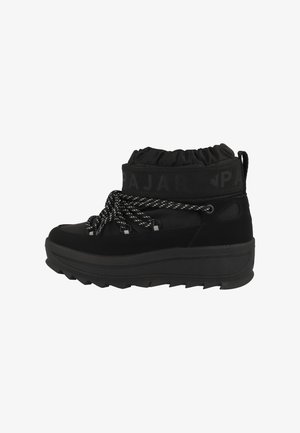 Black ankle boot with a textured upper, elastic cuff, and contrasting white laces. Features a chunky sole with a treaded pattern for traction.