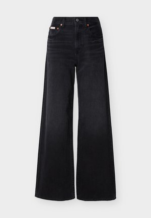 Melnas platām kāju džinsu bikses ar augstu jostasvietu, priekšpusē ar pogu un rāvējslēdzēju, jostu cilpām un piecu kabatu dizainu.