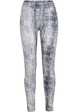 Svart-hvite legginger med slangeskinnmønster laget av elastisk stoff, med en jevn tekstur og tettsittende design.