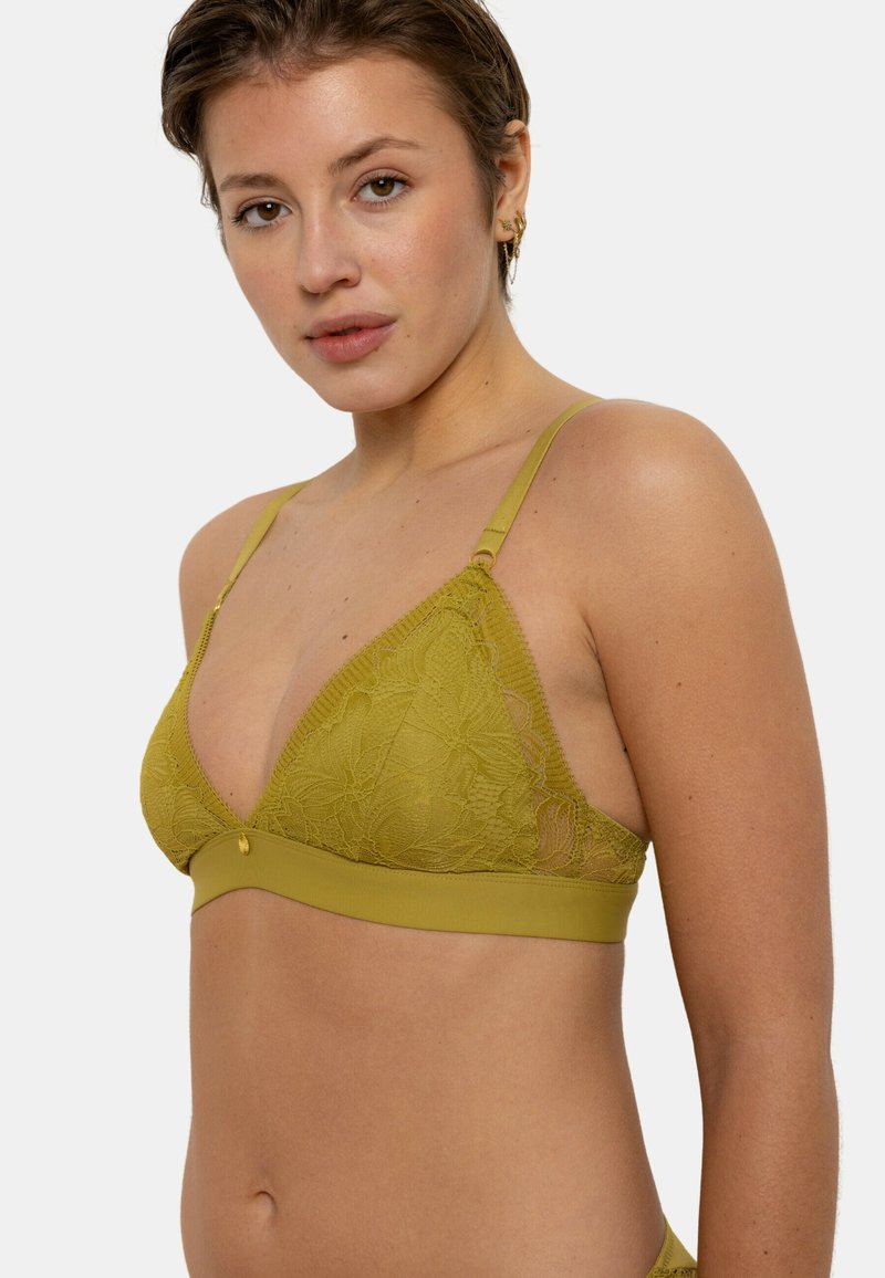 Bralette en dentelle verte avec une forme triangulaire, un motif floral et une bande douce. Bretelles ajustables et un petit détail d'accent au centre.