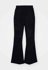 Sorte flared bukser lavet af blødt stof med flere store slidte lapper. Elastisk talje og afslappet pasform for komfort.