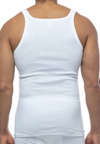 White cotton tank top with wide straps, fitted design, and smooth texture. Back view shows streamlined body fit. No visible logos or patterns.