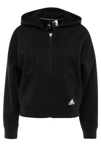 Felpa con zip nera realizzata in tessuto morbido, dotata di cappuccio con coulisse, tasche frontali e logo Adidas bianco in fondo.