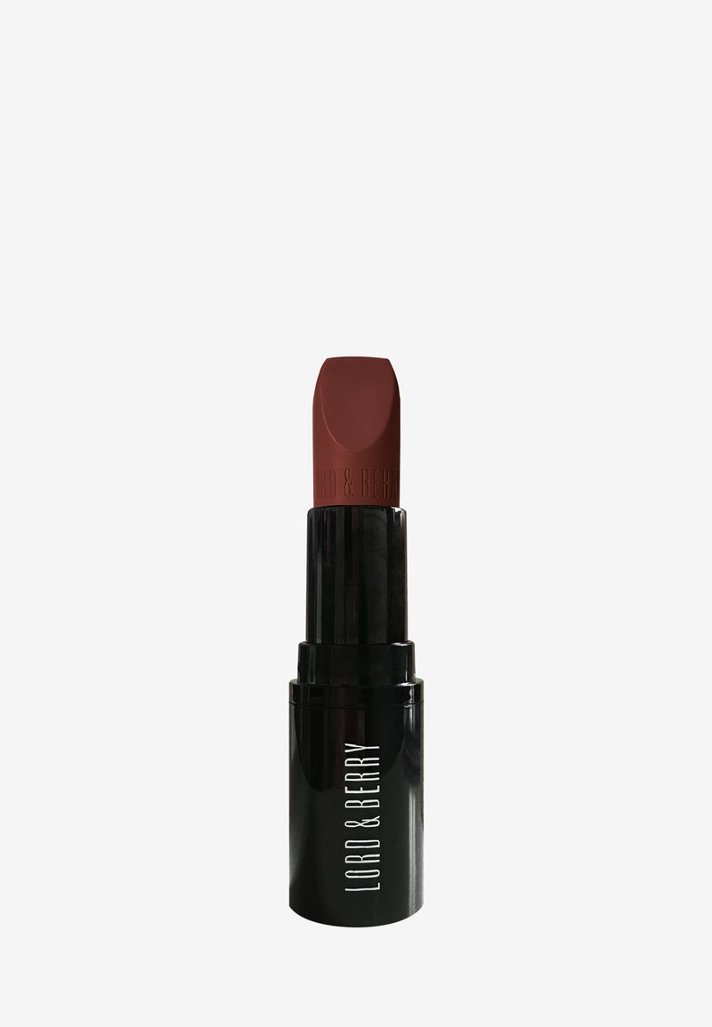 Brun läppstift i ett svart cylindriskt hölje, med en matt yta och en fyrkantig spets med varumärket präglat.