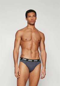 Mutande grigie con un elastico nero che presenta il logo "DIM". Il design è semplice, aderente e realizzato in un tessuto liscio.