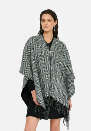 Poncho a scacchi in bianco e nero con bordi frangiati; presenta un colletto e un dettaglio con chiusura; realizzato in tessuto tessuto con un aspetto texture.