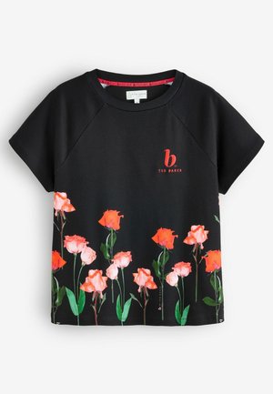 Zwarte T-shirt met korte mouwen en rode bloemenprint aan de onderkant, evenals een logo in het rood op de borst. Zachte stof met een relaxte pasvorm.