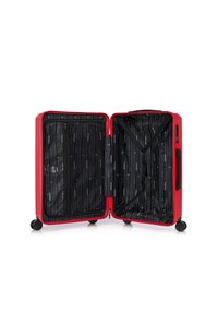 Valigia rigida rossa, aperta per rivelare un interno nero con motivo a righe, include un compartimento con zip e cinghie elastiche per la sicurezza.