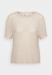 Beige gebreide top met korte mouwen, voorzien van een ronde halslijn en een ruime pasvorm. De textuur is semi-doorschijnend met een fijne, gelijkmatige steekpatroon.