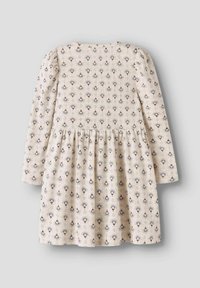 Vestido de mangas largas en color crema, con un patrón floral en azul y marrón. Tejido texturizado con falda con fruncidos y escote redondeado.
