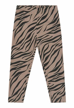 Leggings beiges avec des rayures zébrées noires, taille élastique et jambes ajustées longueur totale.