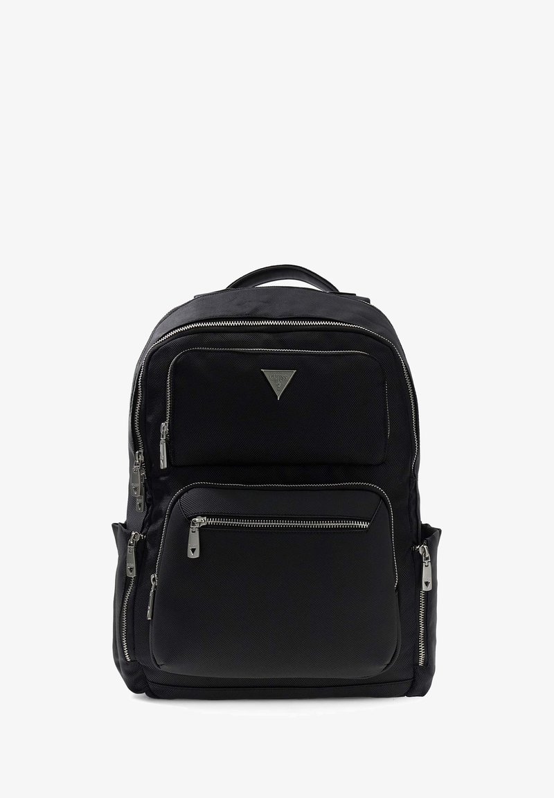 Black fabric backpack with multiple zippered pockets, a triangular logo, and silver hardware accents. Adjustable straps and top handle included.