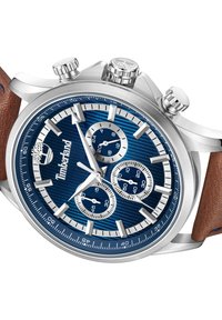 Orologio in acciaio inox argentato con quadrante blu testurizzato, minuteria argentata e cinturino in pelle marrone. Presenta tre pulsanti e un logo.