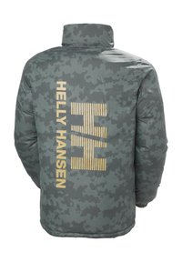 Šedá camouflážní pufová bunda s vysokým límcem, vyznačující se velkým zlatým logem "Helly Hansen" a horizontálními pruhy na zádech.