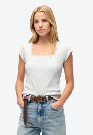 Lys grå ribbet t-shirt med firkantet udskæring og flæseærmer, parret med lyseblå slidte jeans og et brunt læderbælte.