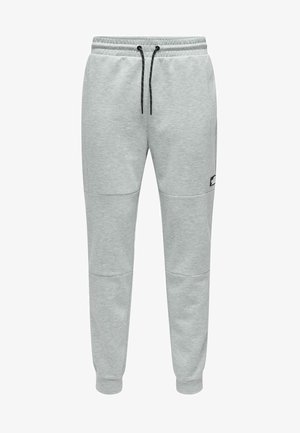 Grijze sweatpants met een taps toelopend ontwerp, een elastische tailleband, een verstelbare trekkoord en zijzakken. Zachte stof met een gladde textuur.