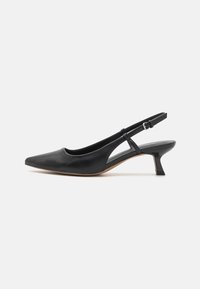 Black leather slingback shoe with a pointed toe, low block heel, cut-out side detail, and adjustable ankle strap. Smooth texture throughout.