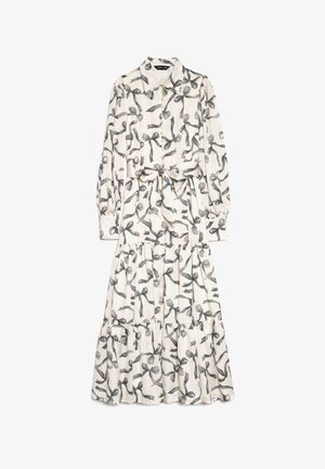 Robe à manches longues avec un col, motif ruban noir et blanc, taille ceinturée, jupe à volants et détails à boutons.