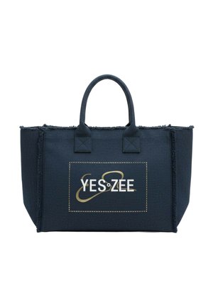Borsa tote blu navy con due manici, bordi sfrangiati e logo "YES ZEE" con design oro e bianco sul pannello frontale.