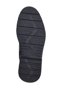 Zwarte rubberen zool met gestructureerd oppervlak, meerdere profielpatronen en een klein logo-detail. Ontworpen voor grip en duurzaamheid.