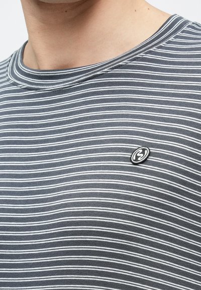 Szürke-fehér csíkos póló bordázott kerek nyakkivágással és egy kis fekete logóval a bal oldalon. Puha pamut anyagból készült.