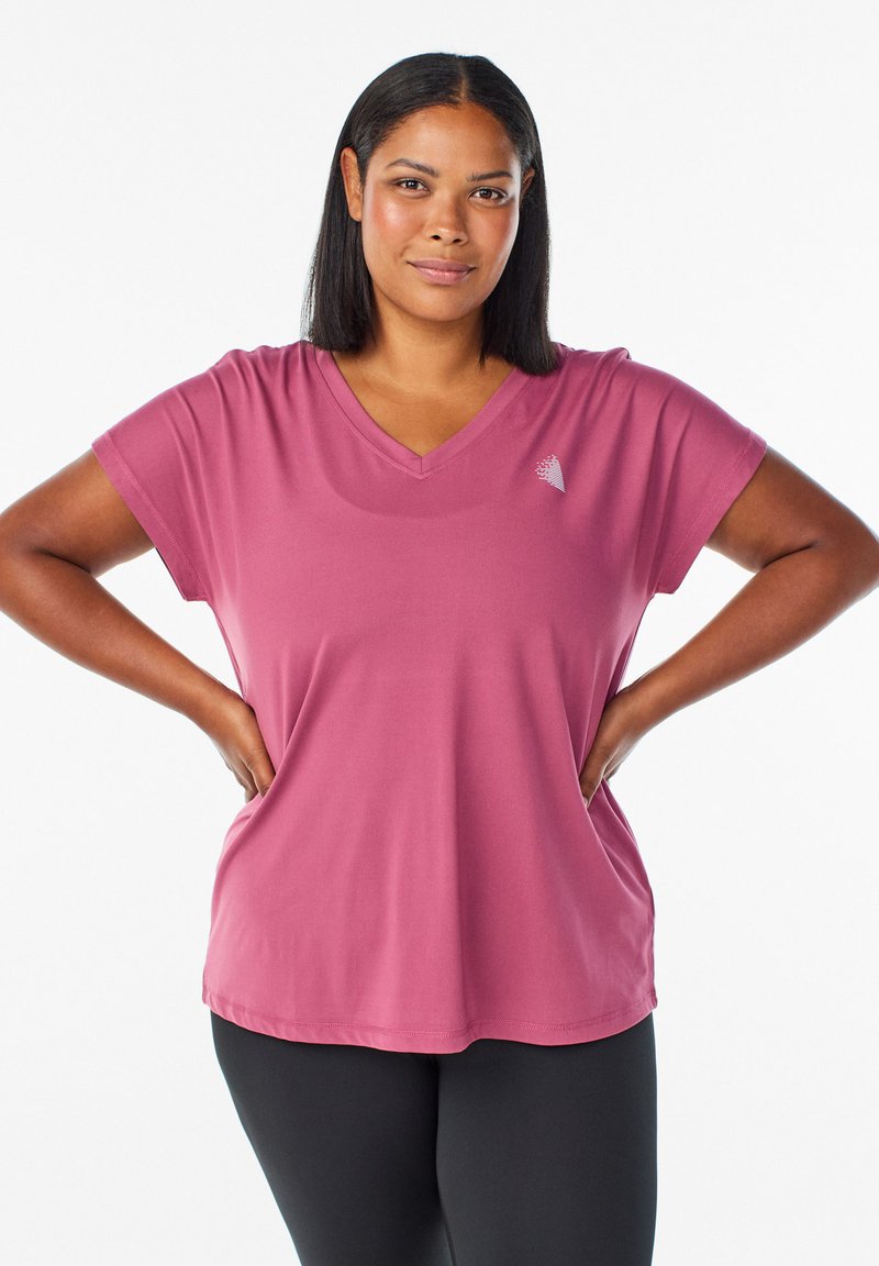 V-neck, short-sleeve top in a soft mauve fabric. Features a subtle logo detail on the chest and a loose, relaxed fit.