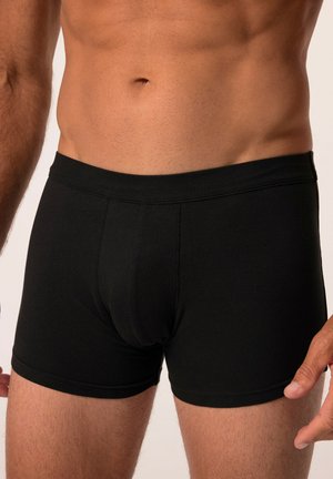 Boxers en coton noirs avec une texture douce, taille élastique et un détail de poche à l'avant. Design ajusté, longueur mi-cuisse.