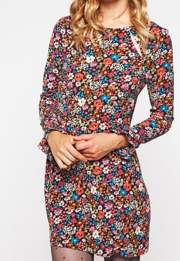 Floral dress with long sleeves, multicolored print featuring red, blue, and white flowers on a dark background, knee-length with a slight frill.