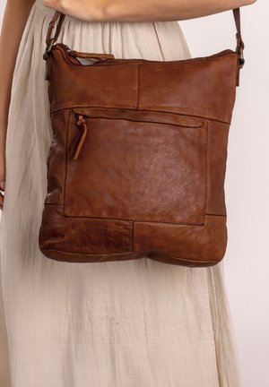 Brown leather shoulder bag with a textured finish, featuring a front zipper pocket and a detachable shoulder strap. Rectangular shape.