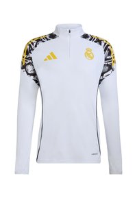 White long-sleeve athletic top with a half-zip, featuring black and yellow accents, a team logo, and abstract patterns on shoulders.