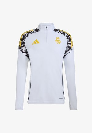 Biała sportowa bluza z długim rękawem i półzamkiem, z czarnymi i żółtymi akcentami, logo drużyny oraz abstrakcyjnymi wzorami na ramionach.