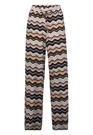 Pantalons larges multicolores présentant un motif en zigzag beige, marron et noir, avec une taille élastique et un détail de cordon de serrage.