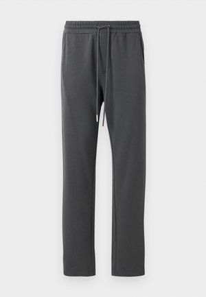 Gray sweatpants with an elastic waistband and drawstring; features side pockets and a smooth texture. Tapered leg design.