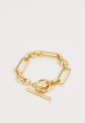 Bracelet en chaîne dorée comportant des maillons rectangulaires et ronds de grande taille alternés, avec un fermoir à bascule. Fini lisse et brillant.