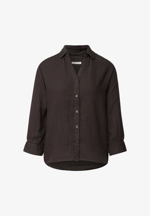 Camicia button-up a maniche lunghe di colore marrone scuro, realizzata in un tessuto strutturato. Presenta un colletto, spalle scese e un orlo curvo.