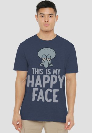 Navy blue cotton t-shirt featuring a graphic of a gray cartoon character with the text "THIS IS MY HAPPY FACE" below. Simple, casual design.