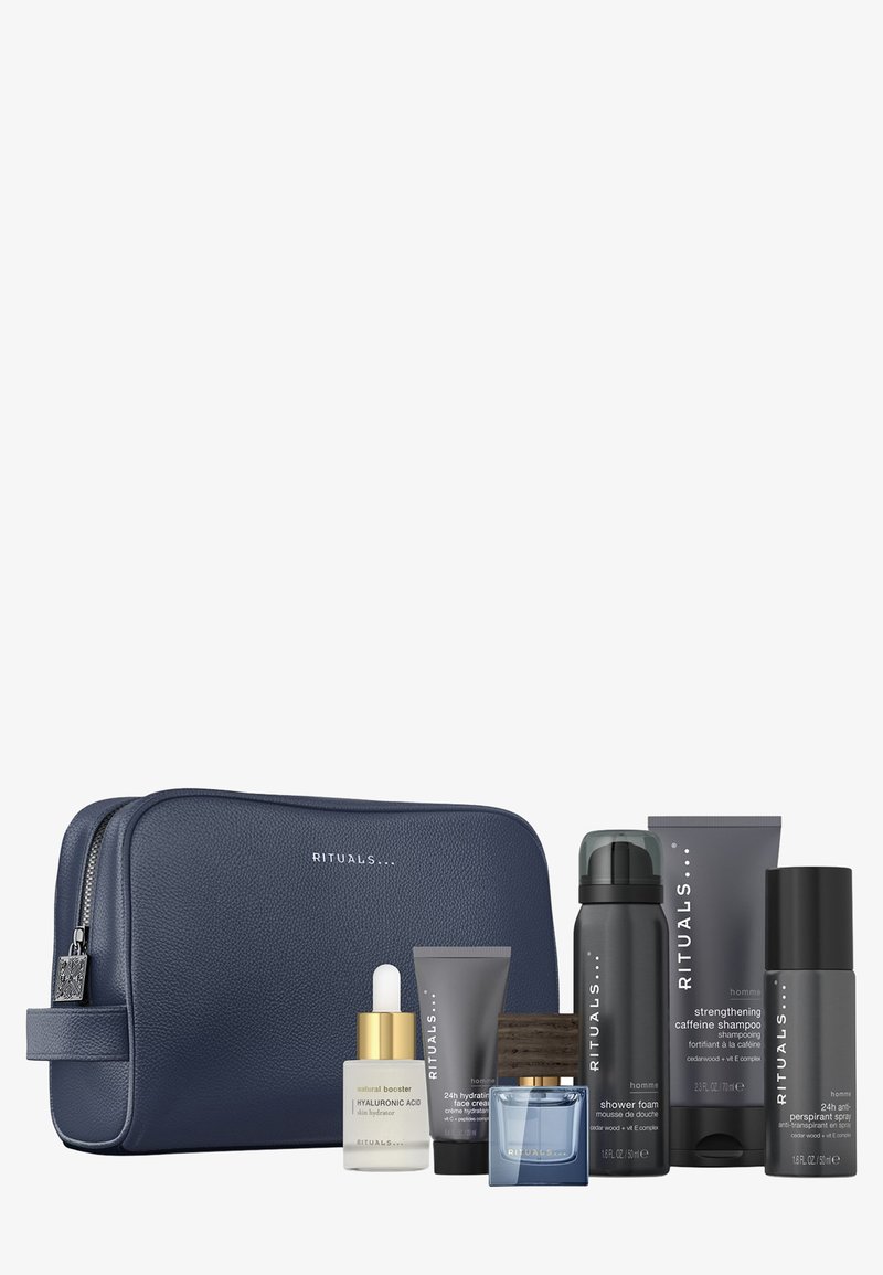 Rituals verzorgingsset met een marineblauwe, gestructureerde etui, zes producten waaronder shampoo, moisturizer en serum in verschillende maten en kleuren.