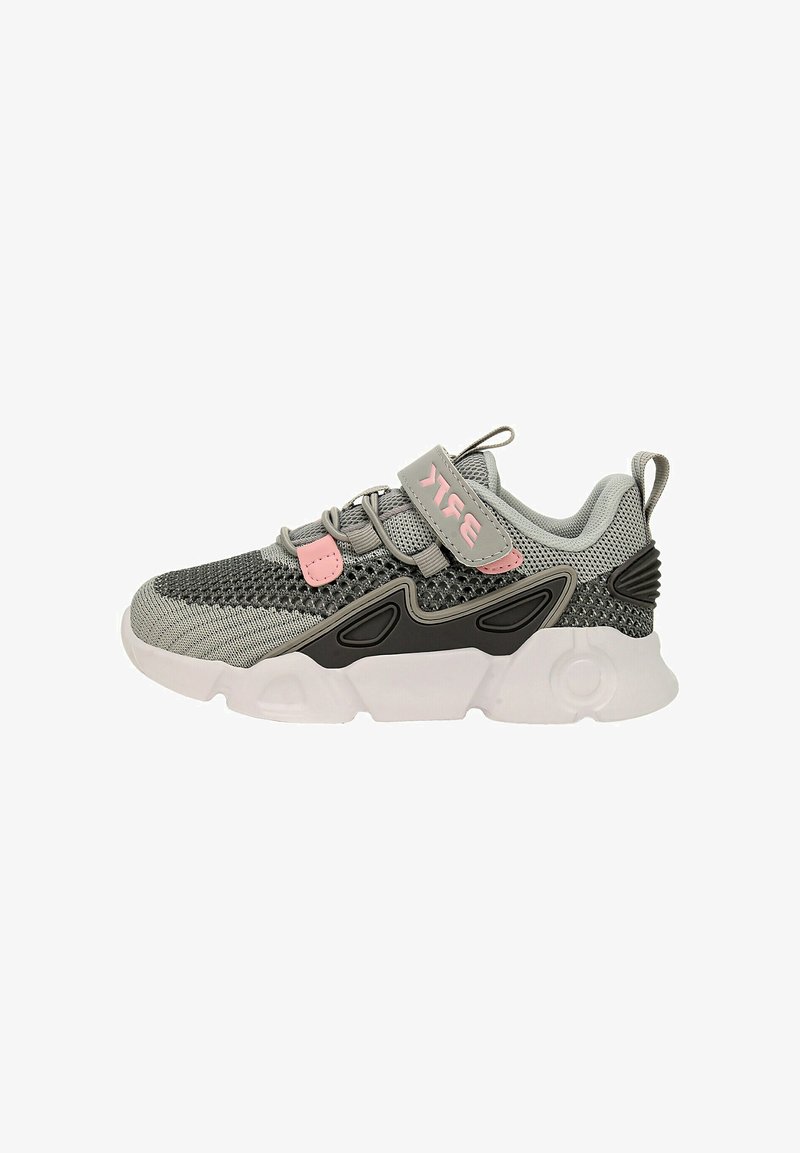 Gray athletic shoe with pink and black accents. Features mesh upper, adjustable strap, textured sole, and modern design elements.