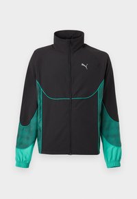 Veste de sport noire et turquoise avec fermeture éclair complète à l'avant, col haut, poignets élastiques et logo Puma sur le côté gauche de la poitrine.