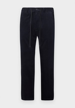 Pantalons en velours côtelé bleu marine avec une surface texturée, jambes droites, taille élastique, cordon de serrage et poches avant.