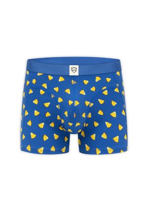 Calzoncillos bóxer azules para hombre con estampado amarillo de tacos y una pequeña etiqueta blanca con la cara de un león en la cintura.