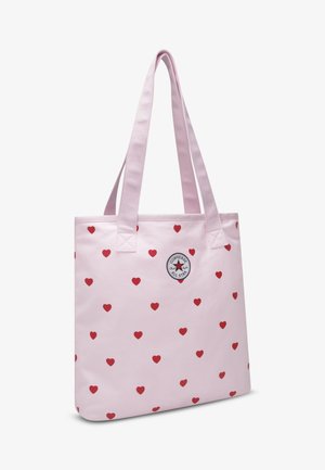 Lichtroze totebag met rood hartjespatroon, rechthoekige vorm, dubbele stevige hengsels en een ronde Converse All Star-logopatch.
