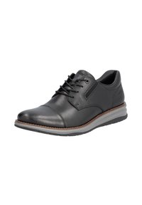 Zapato de cuero negro con punta redonda, diseño con cordones y suela de goma contrastante. Presenta costuras sutiles y una textura suave.
